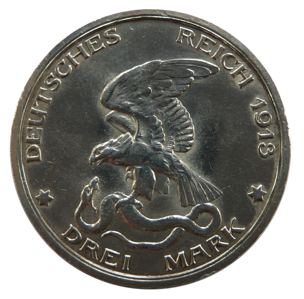 Eine Silbermünze mit einem Adler, der eine Schlange umklammert, mit ausgebreiteten Flügeln und der Aufschrift "Deutsches Reich" auf einem weißen Hintergrund.