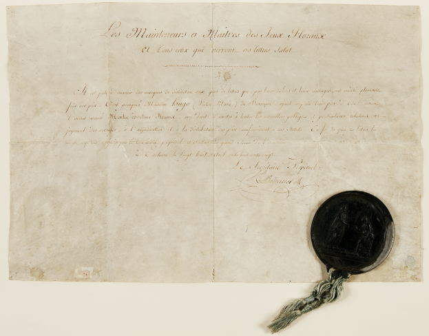 Ein altes Dokument mit einem Wachssiegel, das wie ein Vertrag mit Text und einem Wachsstempel aussieht.