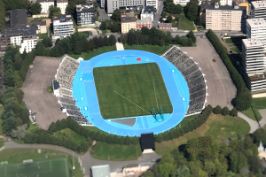 Luftaufnahme des Olympiastadions in München, Deutschland, umgeben von Stadtgebäuden, Bäumen, Straßen, Fahrzeugen und Gras.